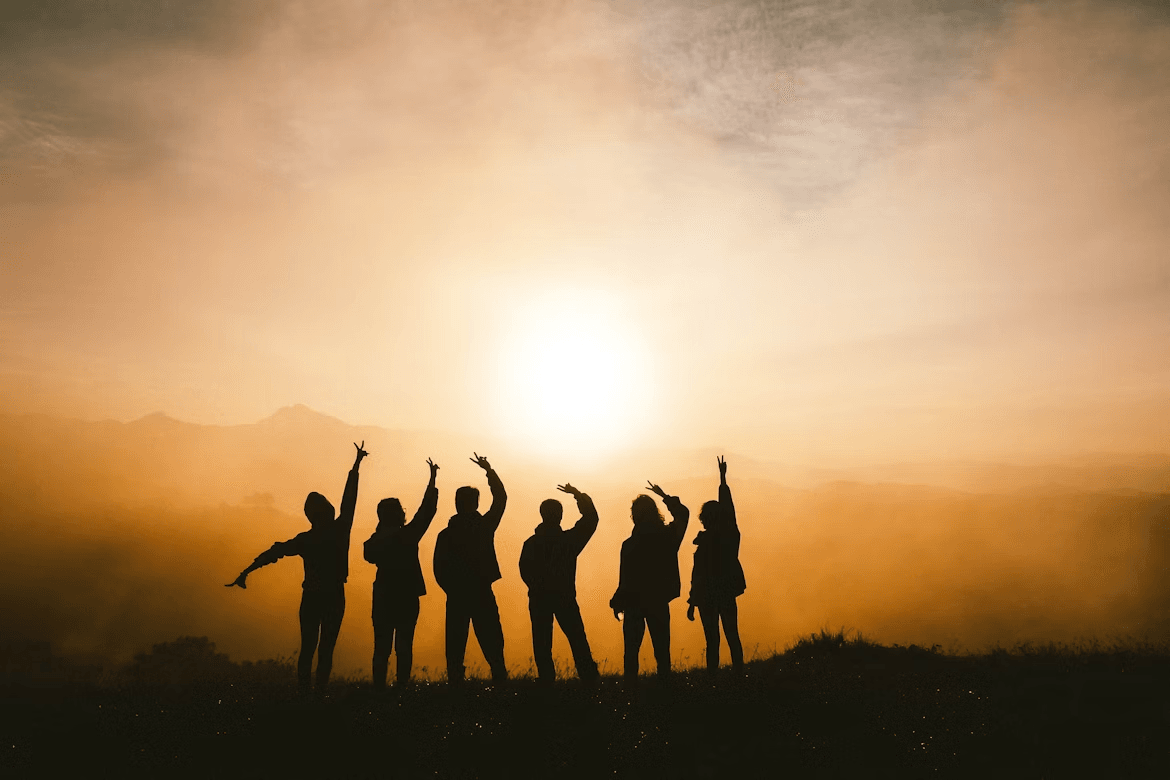Silhouette of six people against the sunrise